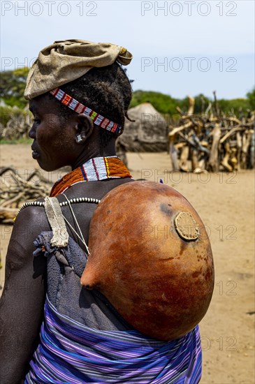 Woman with a gourd on her back from the Toposa tribe