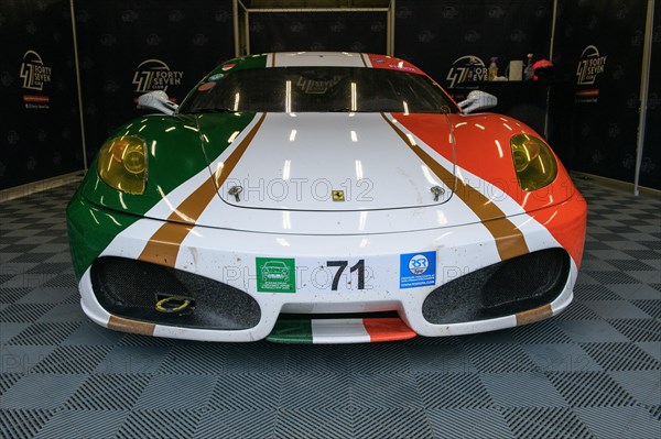 Ferrari F430 in Italian national flag design stands in pit in pit lane