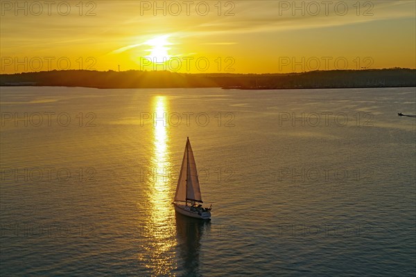 Sailing ship in the Kiel Fjord at sunset