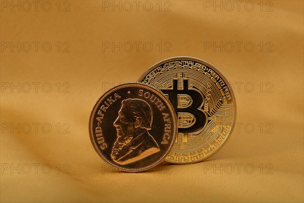 Physical gold coin 1 oz gold Krugerrand obverse Paul Kruger and physical bitcoin coin