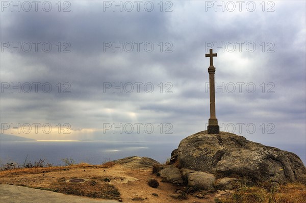 Stone cross on rock