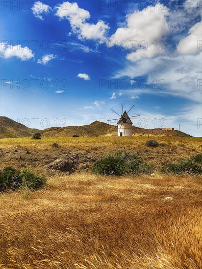 Windmill in barren landscape