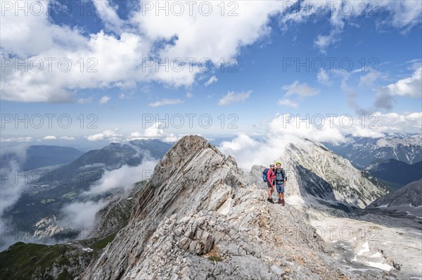 Young couple standing together at the summit after a hike