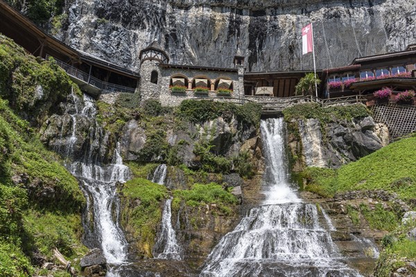 Ensemble of buildings with waterfall in front of the Saint Beatus Caves