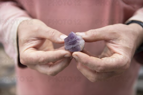 Hands holding an amethyst