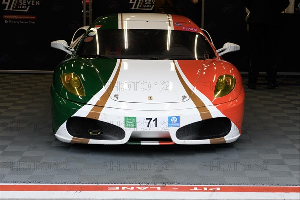 Ferrari F430 in design of Italian national flag stands in pit in pit lane