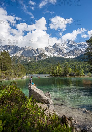 Young man sitting on a rock