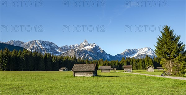 Meadow with hay barns