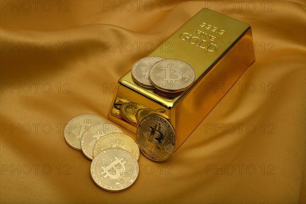 Gold bar fine gold fineness 999.9 and Bitcoin cryptocurrency