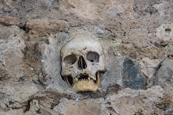 Stone structure embedded with human skulls