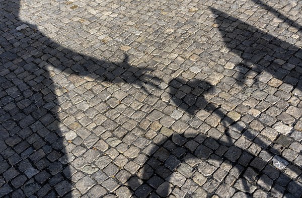 Shadow of the hand of a bicycle thief