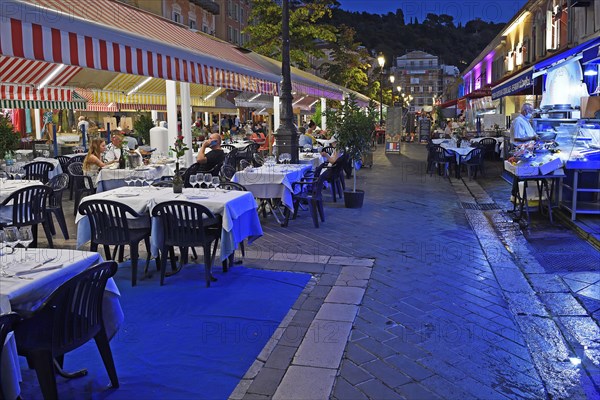Evening hustle and bustle with restaurants and market stalls on the Cours Saleya