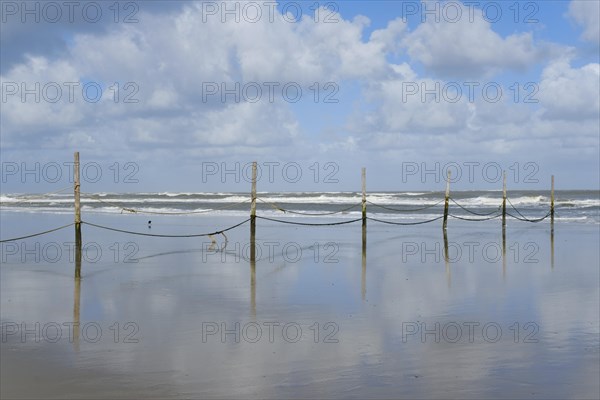 Wooden piles with ropes for demarcating the bathing area