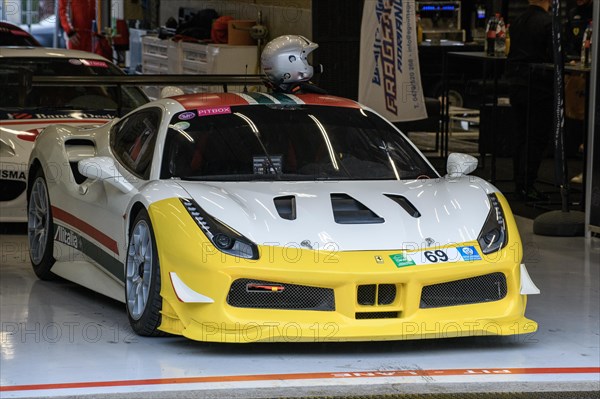 Ferrari 488 Challenge stands in pit box in pit lane