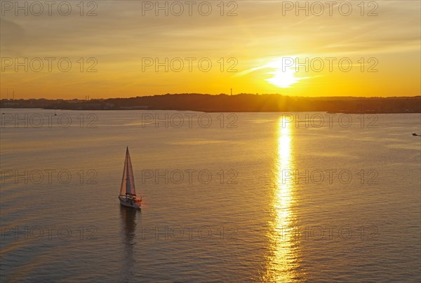 Sailing ship in the Kiel Fjord at sunset