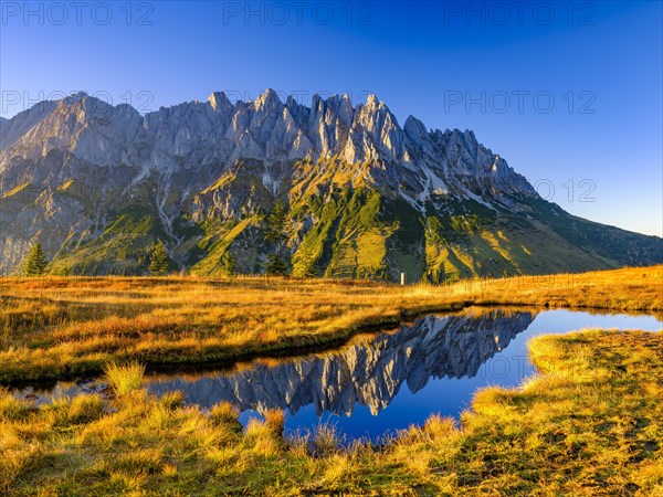 Mandl walls reflected in a mountain lake