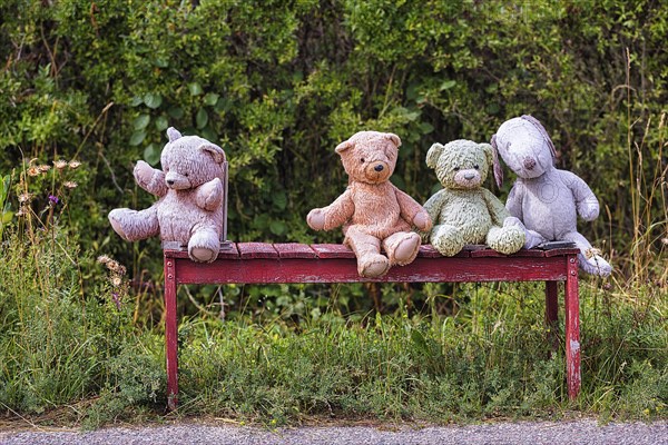 Four different coloured stuffed animals