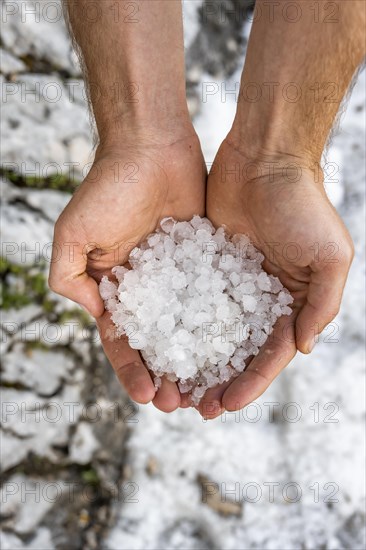 Two hands holding hailstones