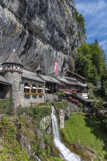 Ensemble of buildings with waterfall in front of the Saint Beatus Caves