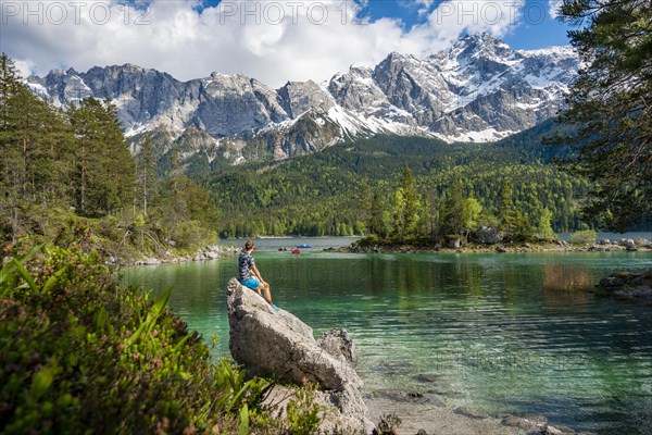 Young man sitting on a rock