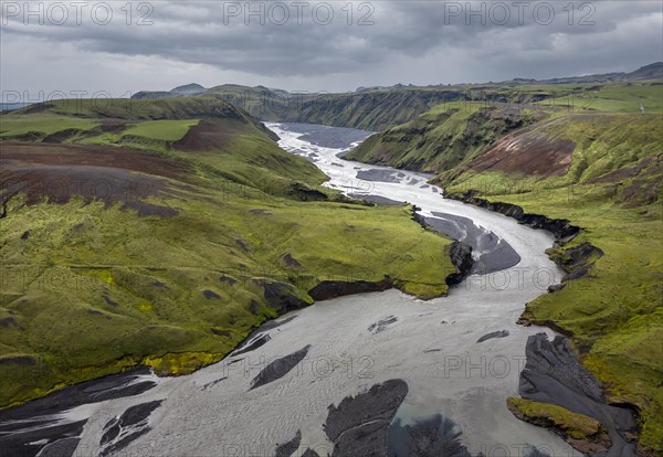 River with fanned out branches through black lava sand