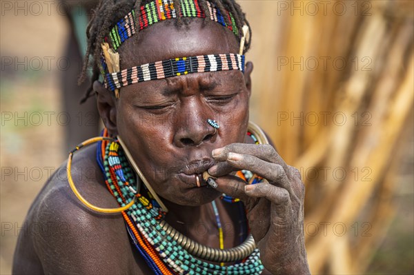 Traditional dressed women smoking