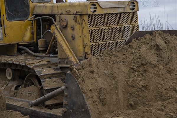 Bulldozer removes dam in the delta Danube river