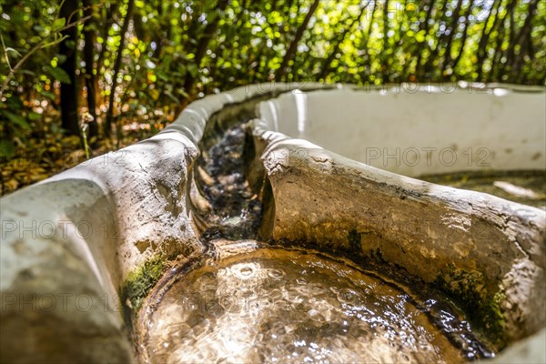 Water flowing in the handrail in Generalife garden in palace complex called Alhambra in Granada