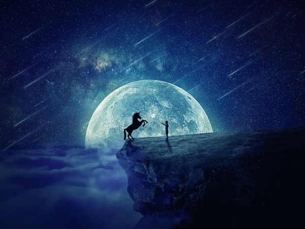 Night scene with a boy standing at the edge of a cliff chasm trying to tame a wild unicorn