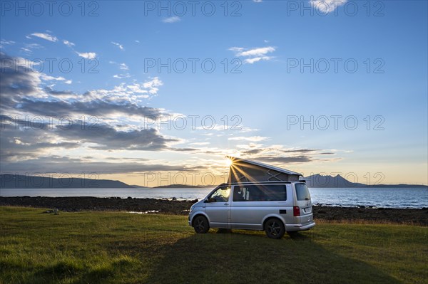 Camper standing by fjord