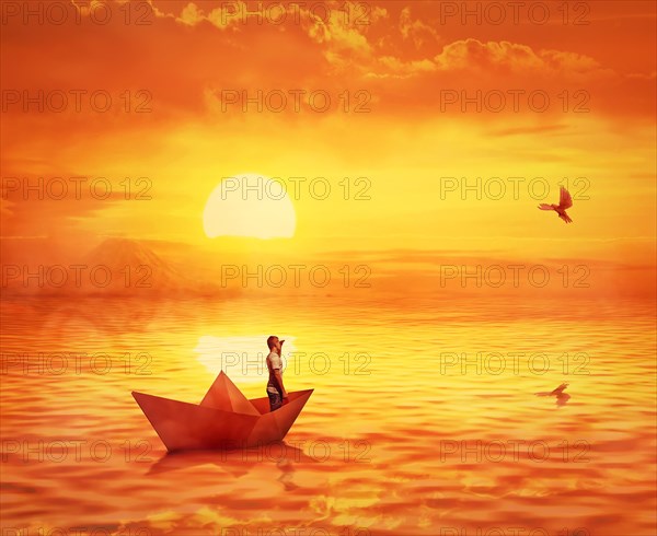 Silhouette of a lonely boy in a paper boat sailing lost in the ocean