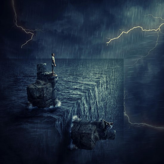 Conceptual image with a lost man sitting on a rock cliff island