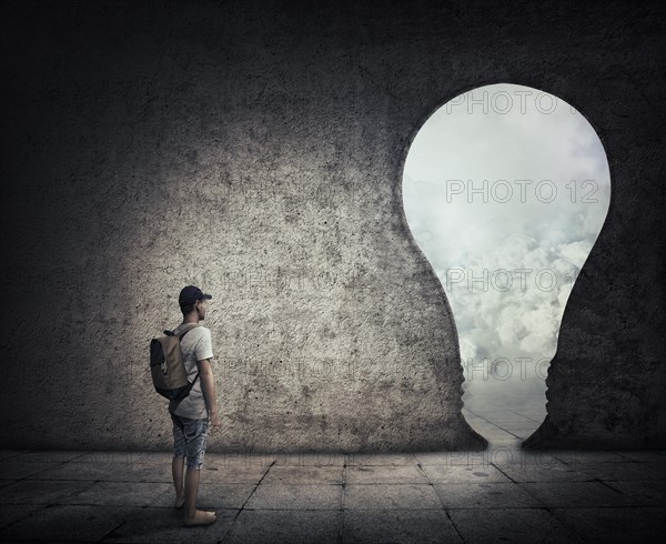 Conceptual image with a person standing in a dark room