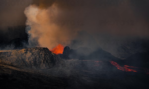 Erupting volcano with lava fountains and lava field