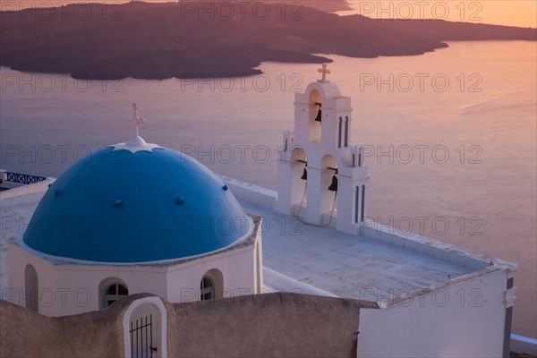 Church with blue dome roof and white three bell tower at the crater rim