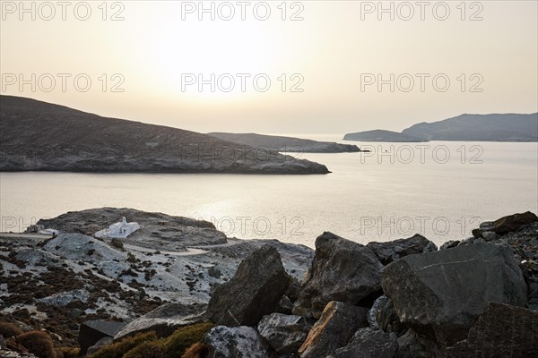 Coast of Tinos at the narrowest point to Andros in the unusual white sunset light