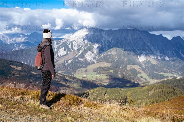 Woman looking at the mountain group Leoganger Steinberge