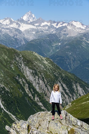 Young girl posing before the Swiss Alps