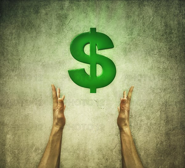 Closeup of two human hands holding a green dollar sign