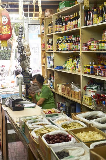 Small shop with bottles and canned goods on the shelf