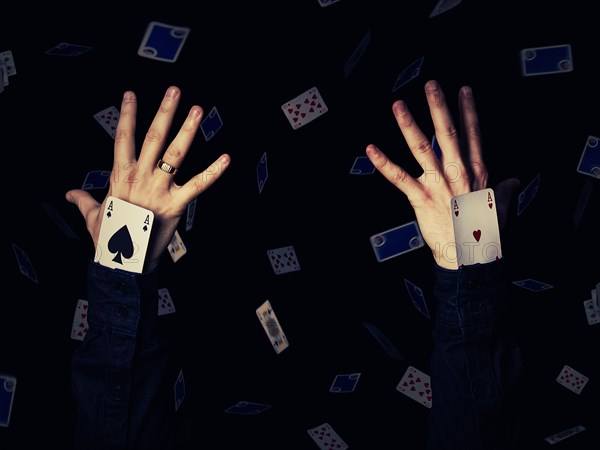 Close up of two human hands holding aces playing cards in the sleeve
