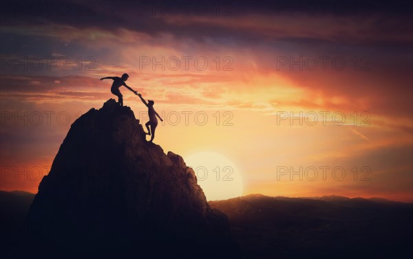 Scenery view with a team of two climbers on the top on the mountain