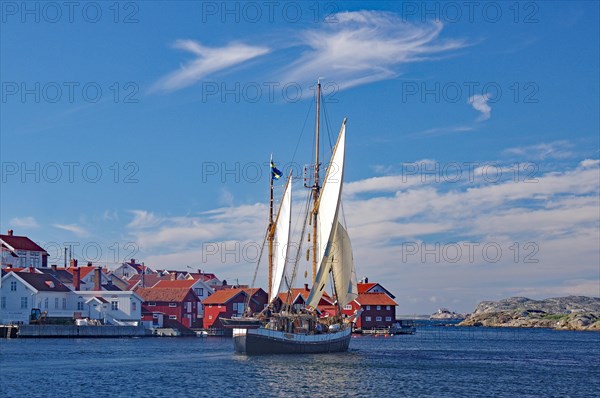 Sailing boat in front of small islands and archipelago