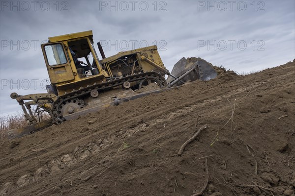 Bulldozer removes dam in the delta Danube river