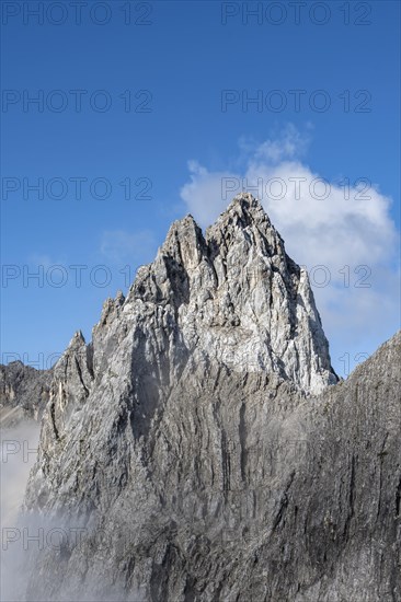 Rocky mountain peak with summit cross