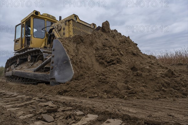 Bulldozer removes dam in the delta Danube river