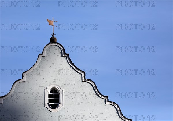 Gable of a historic building with weather vane