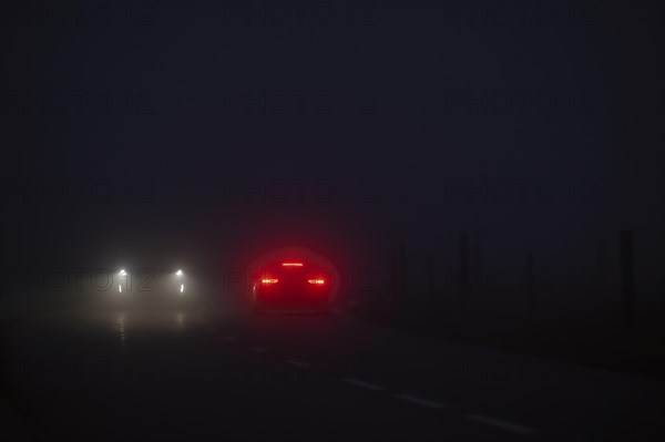 Cars in night and fog oncoming traffic