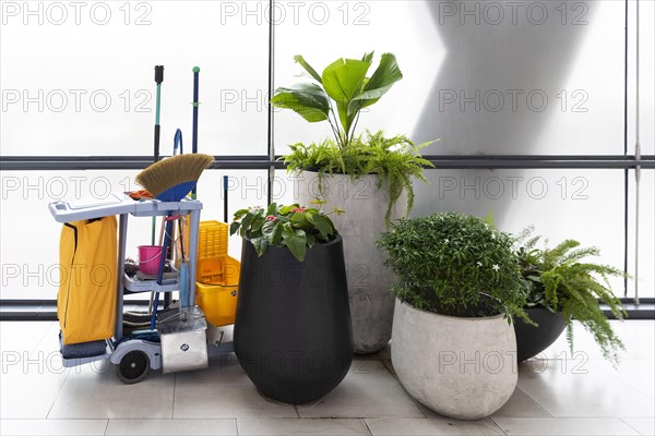 Cleaning trolley with broom and utensils