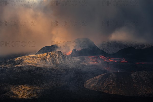 Erupting volcano with lava fountains and lava field